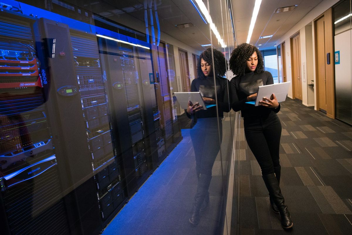 Engineer reviewing systems inside a data center corridor